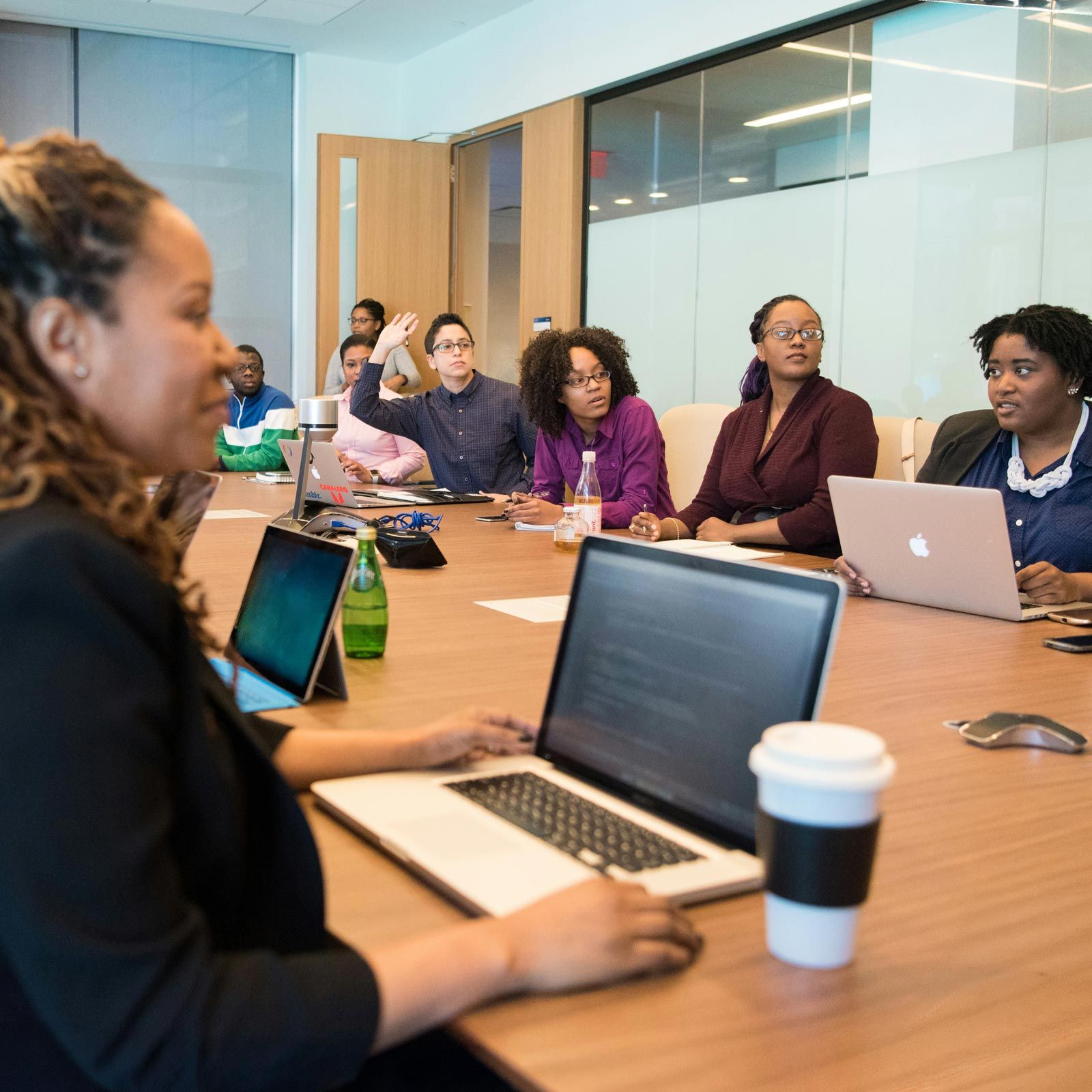 staff meeting in conference room with laptops